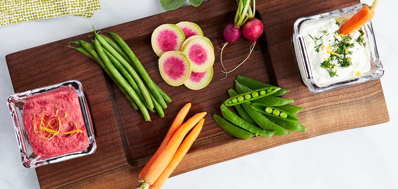  donmore wood cutting board with simon pearce glasses shown with fresh vegetables and dips