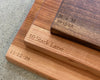 three wood cutting boards shown with engravings