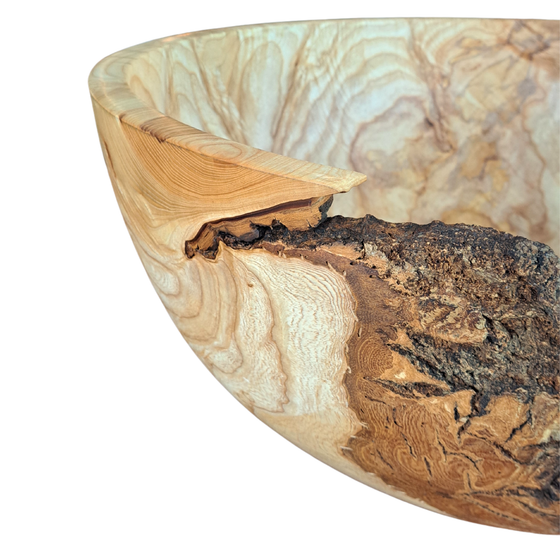 Closeup view of live edge rim of ash burl wood bowl