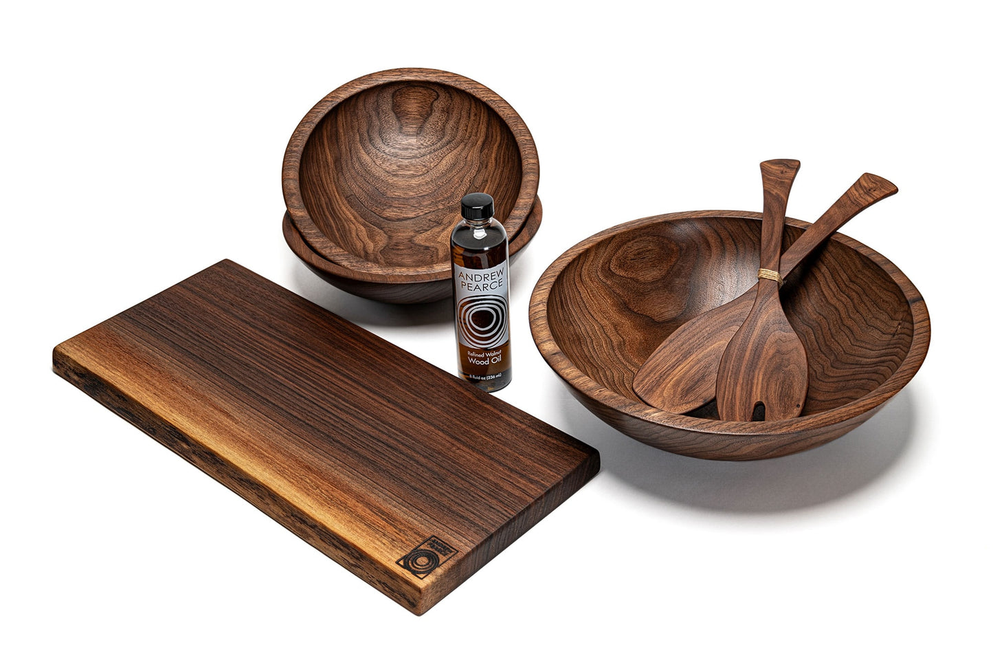 Andrew Pearce Bowls Introductory bundle including a large walnut wooden bowl with match smaller bowls, wood sald servers, wood cutting board and wood oil