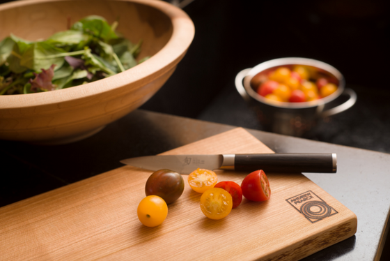 Wooden salad bowl and a large single live edge wood cutting board in cherry