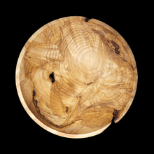  Wooden burl bowl with natural grain and texture on a black background