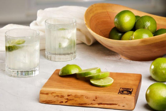 small cutting board used for citrus with a live edge wooden bowl in cherry