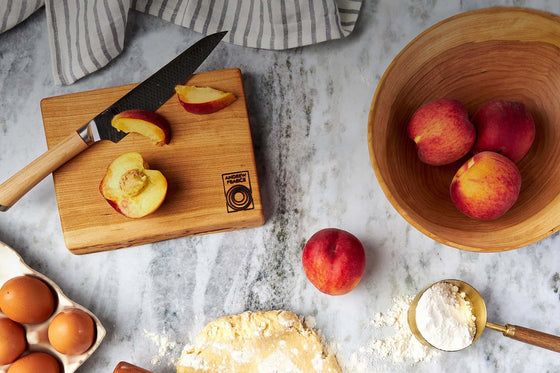 French rolling pin with a live edge wooden bowl and a wood cutting board