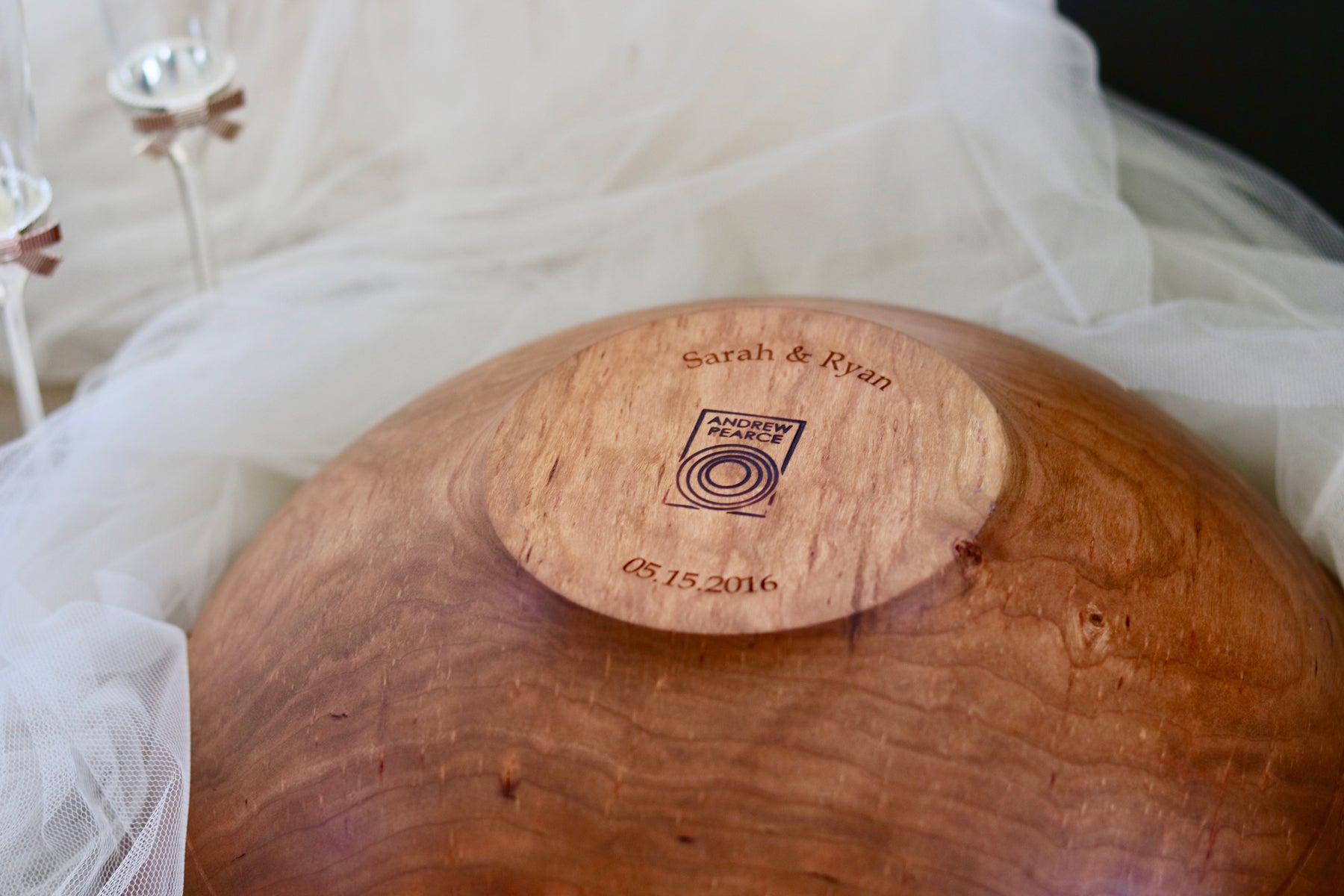 Engraved wooden bowl in cherry shown as a wedding gift