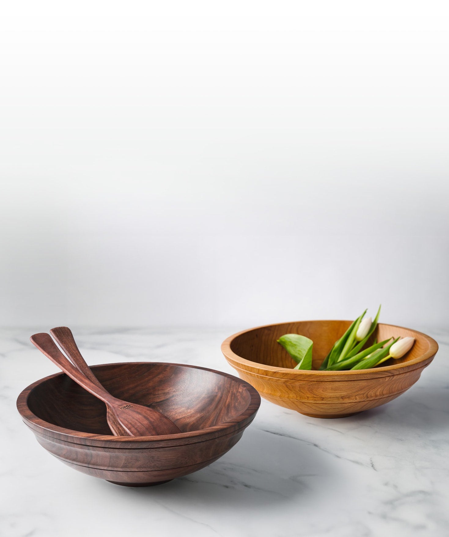 Wooden Bowls from Andrew Pearce Bowls in Hartland VT shown in walnut and cherry with wooden salad servers and fresh cut flowers