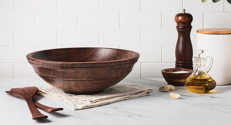  wood salad bowl in walnut shown with matching walnut salad servers